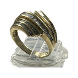 An 18ct yellow gold dress ring, channel set with baguette diamonds over five rows, total weight of