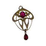 A 9ct gold pendant, set with a red faceted stone to the centre, and another red faceted stone in a