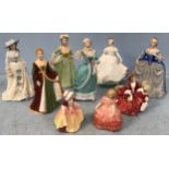 Nine various hand-painted ceramic figures of ladies and girls in decorative gowns, including a