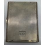 A silver cigarette case by Smith & Bartlam, the outside with engine turned decoration and lozenge