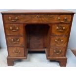 An 18th century and later mahogany kneehole desk of small proportions, tan leather gilt tooled