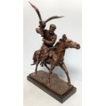 A well-cast and patinated bronze figure of a mounted Arabian man with hunting hawk, unsigned,