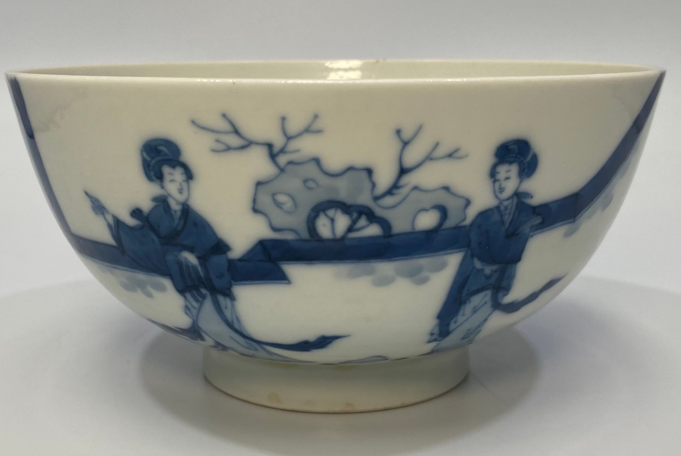 A Chinese porcelain blue and white bowl decorated with ladies in a walled garden with a rabbit,