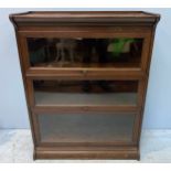 A Globe Wernicke style oak stacking bookcase with three graduated sections, ‘up and over’ glass