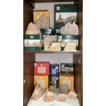 Various Lilliput Lane ‘Paint Your Own’ model cottage blanks over two shelves including ‘Summer