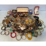 A large quantity of costume jewellery including a silver bangle, pearl necklace, pendants, his’n’