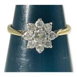 An 18ct yellow gold diamond ring, set with 9 x round brilliant cut diamonds in a daisy cluster