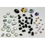 Various loose semi precious stones including green Tourmaline in a variety of cuts, the largest