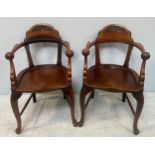 A pair of large Victorian carver chairs with lunette carved crest rails, shaped arm rests with