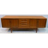 A G-Plan teak sideboard with central bank of four drawers flanked by a pair of cupboards either