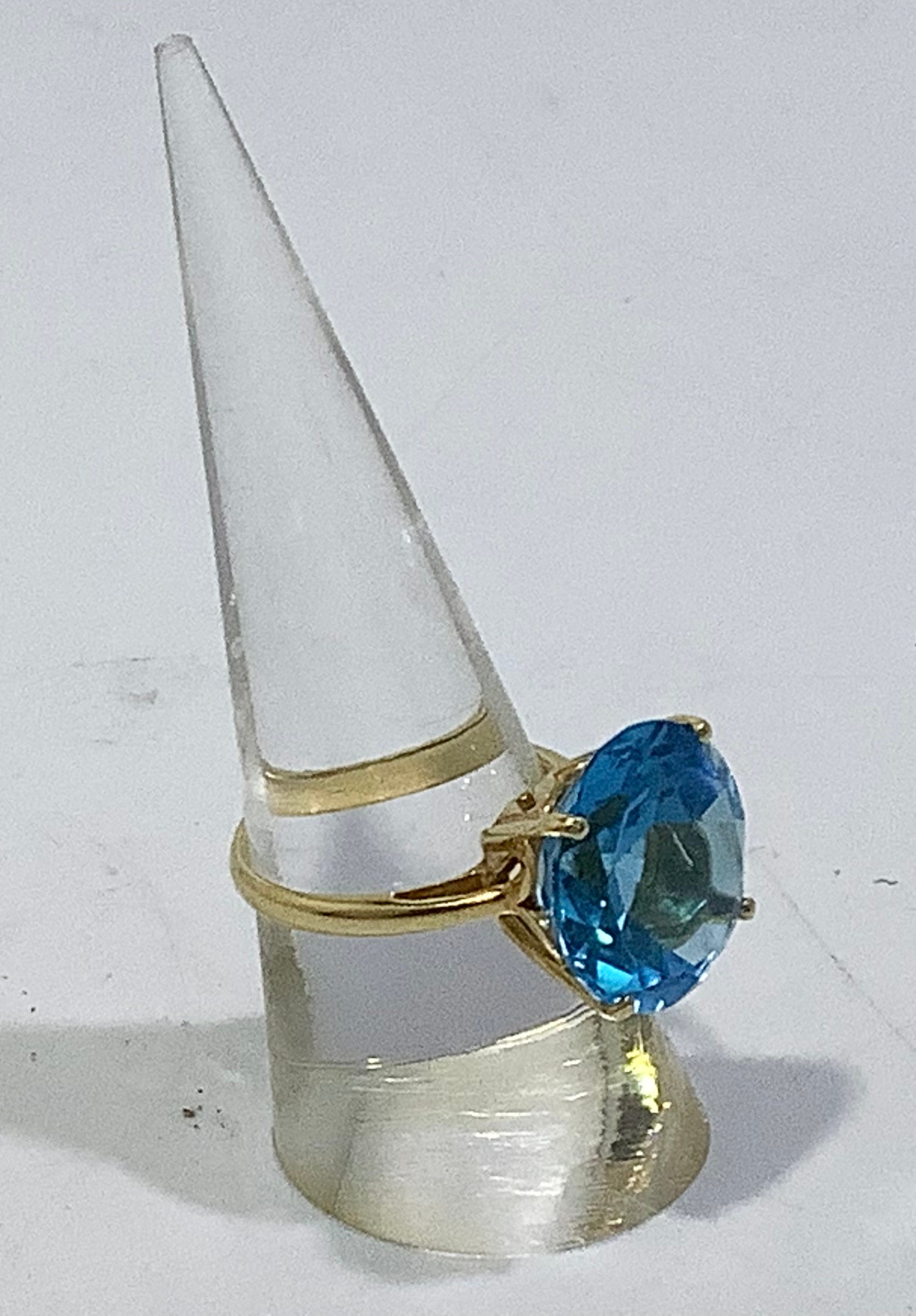 An 18ct gold ring, centrally four-claw set with a large round faceted blue topaz, together with a - Image 2 of 4