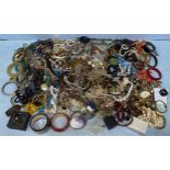 A large quantity of costume jewellery including necklaces, bracelets, shell purse, bangles, pendants