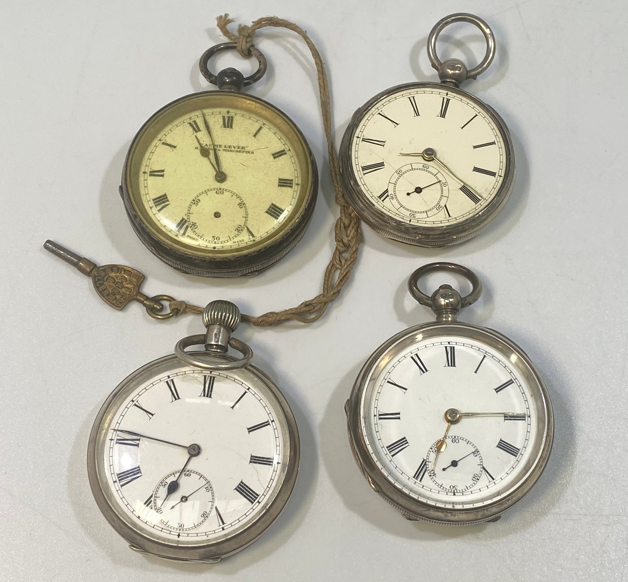 Four various silver-cased open face pocket watches, all with white enamel dials, Roman numerals