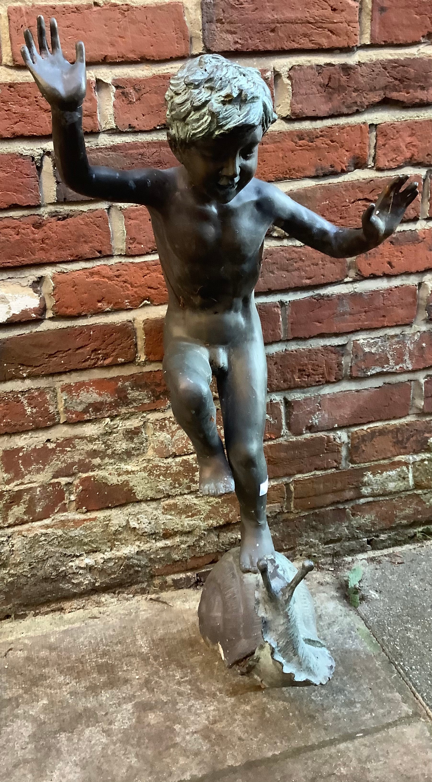 A late 19th / early 20th century copper fountain modelled as a figure of a young boy balancing on