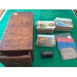 A wooden box containing around 470 postcards comprising around 170 larger modern cards, 130