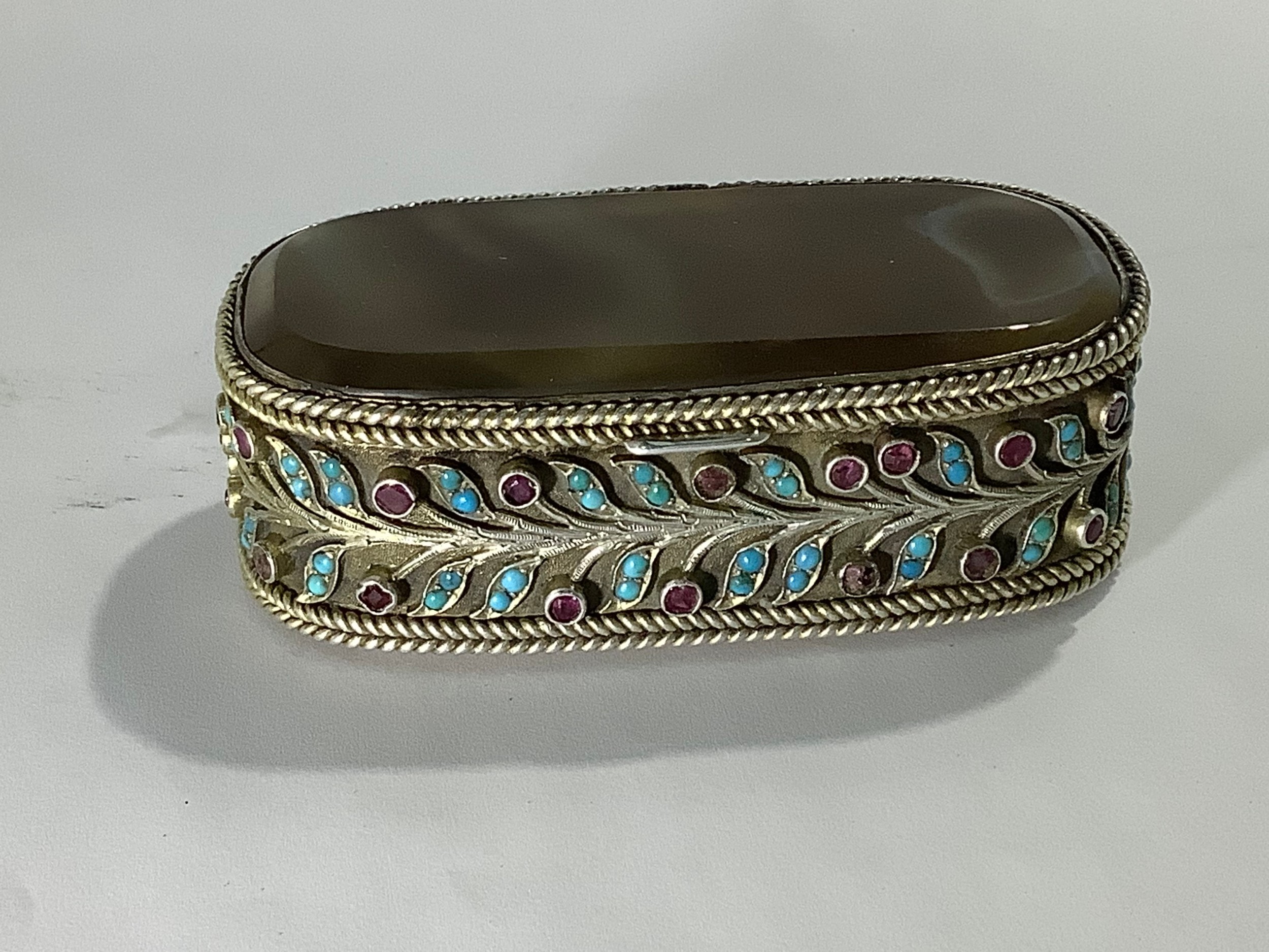 A late19th/early 20th century Indian/Persian white-metal casket of elongated oval form, with inset
