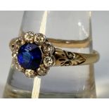 An 18ct gold ring, centrally claw set with a round, faceted sapphire coloured stone (loose in mount)