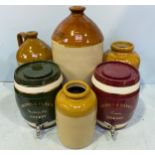 Four various stoneware flagons including one marked ‘John Harris & Son 129 Curtain Road London
