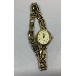 A ladies 9ct gold Rotary Elite wristwatch, the cream, oval dial with gold batons denoting hours
