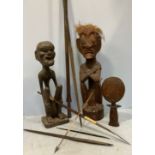 A quantity of African tribal spears including a long pole spear, spear tips and three carved