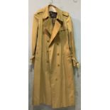 A vintage lady’s Burberrys beige trench coat / mac with Burberrys’ Made in England blue label and