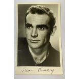 A black and white photo of a young Sean Connery signed in black pen by the actor; provenance - the