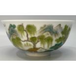 A Chinese porcelain bowl hand painted with a scene of a figure of a man on a raft with houses,