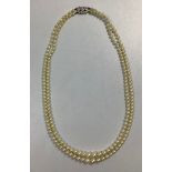 A double-string graduated cultured pearl choker necklace, with 9ct white gold safety clasp, maker