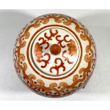 A Chinese porcelain ginger jar and cover of elongated ovoid form, decorated all-over in iron red