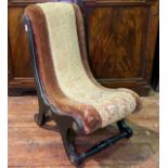 A Victorian slipper chair of small proportions, with ‘X’ frame and turned front and back stretchers