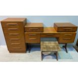 A G-Plan teak dressing table with central drawer flanked by a pair of drawers either side, 136cm