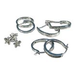 Four pairs of white gold diamond earrings, including hoops and cluster studs, total weight of