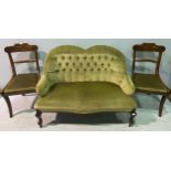 A Victorian two-seater sofa with shaped back, deep-button upholstered in green fabric, raised on