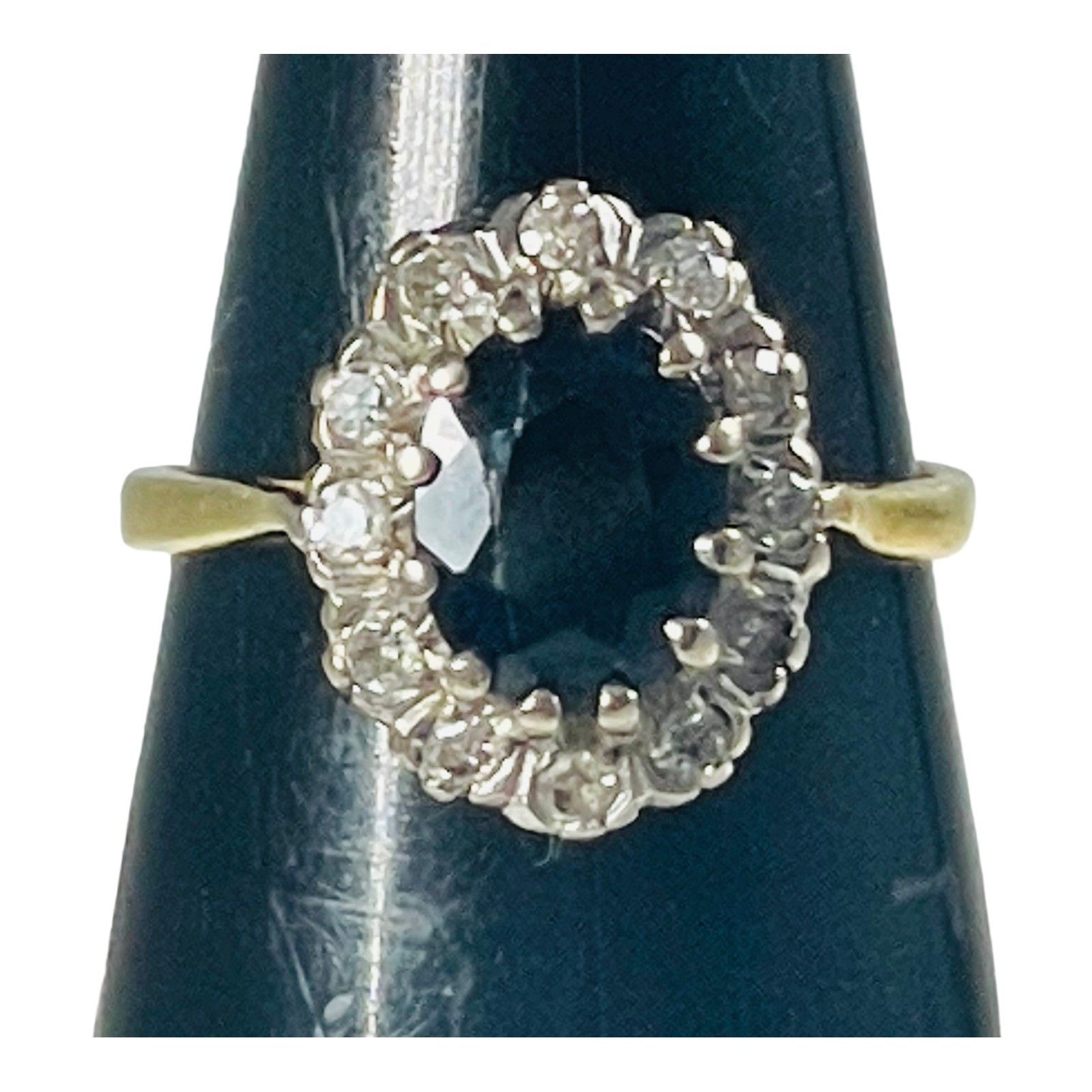 An 18ct yellow gold sapphire and diamond dress ring, set with an oval shaped sapphire to the centre,