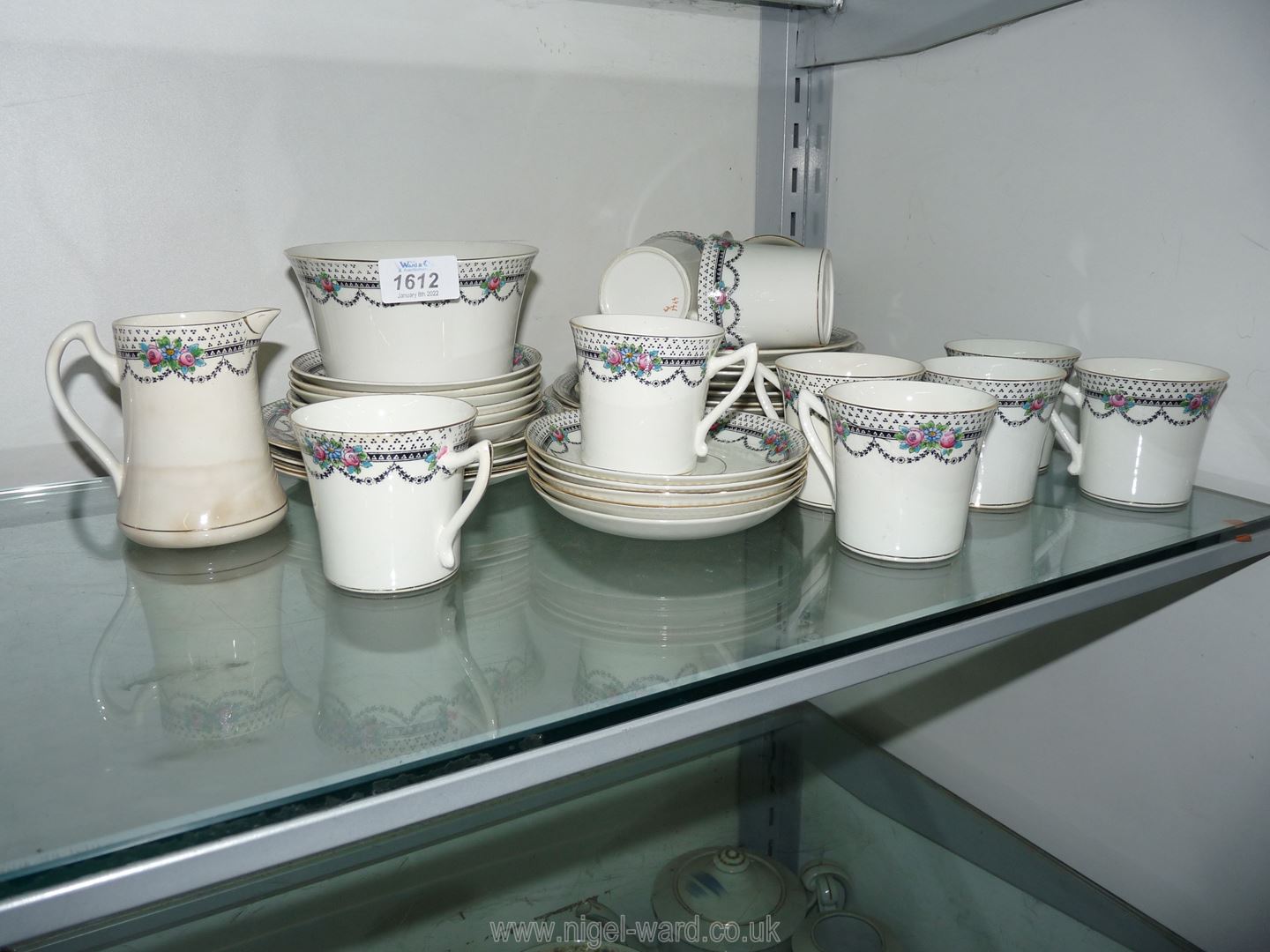 A pretty vintage Tea service black garlands and edging with Peonies, eleven each cups and saucers,