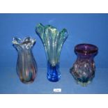 Three large Studio glass vases in various shades of blue to green, yellow to red and blue to red.