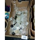 A box of cut glass perfume bottles having bird finials.