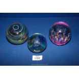 Three paperweights including large dump shape with air bubbles and gold and purple base,