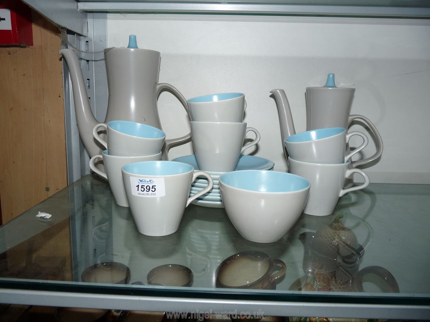 A Poole Pottery coffee set in blue and grey, eight saucers, seven cups,