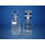 Two cut glass decanters, one square the other round, both with stoppers.