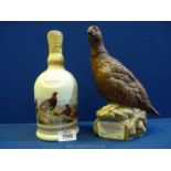 Two Famous Grouse Scotch Whisky decanters: one by Wade commemorating the centenary,