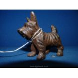 A small cast iron Scottish Terrier, 2 1/2" tall x 3" long.