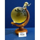 A novelty decanter in the form of a small globe on stand with contents of Highland Malt Scotch