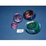 Four paperweights including mottled, swirl, Langham, etc.