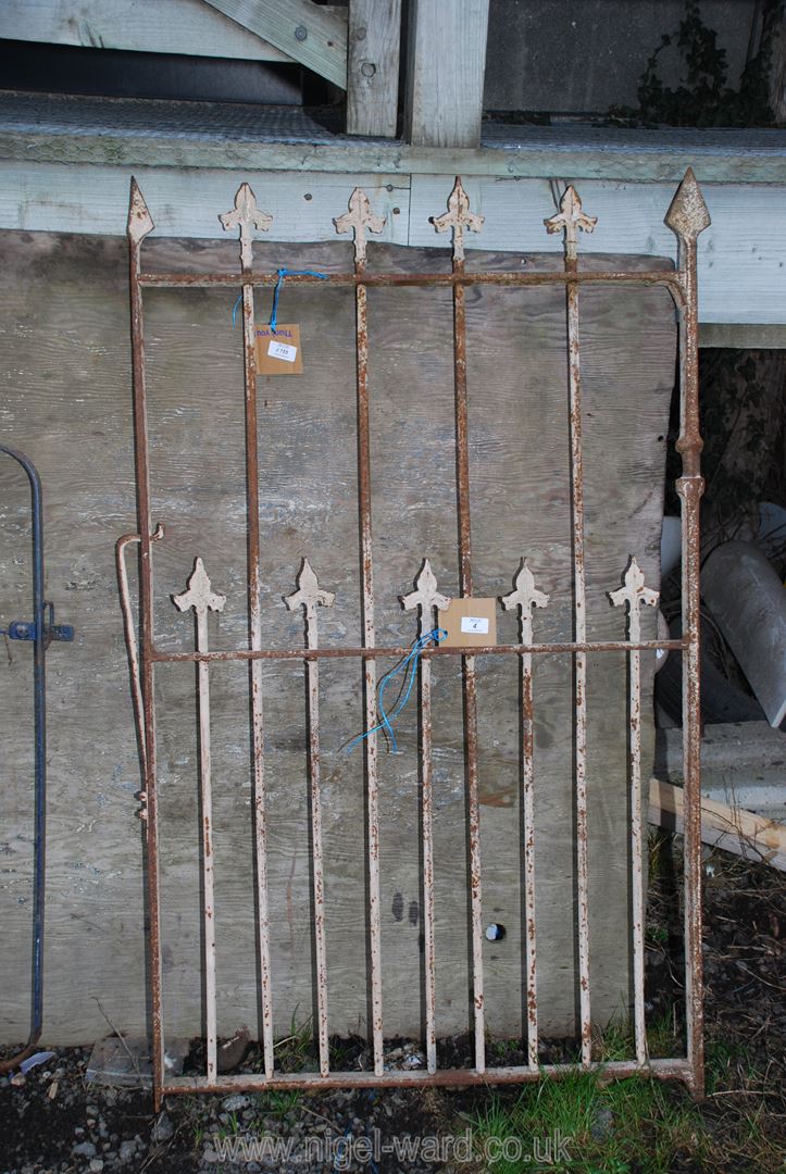 A heavy metal pedestrian gate with arrow head tops 31" x 53".