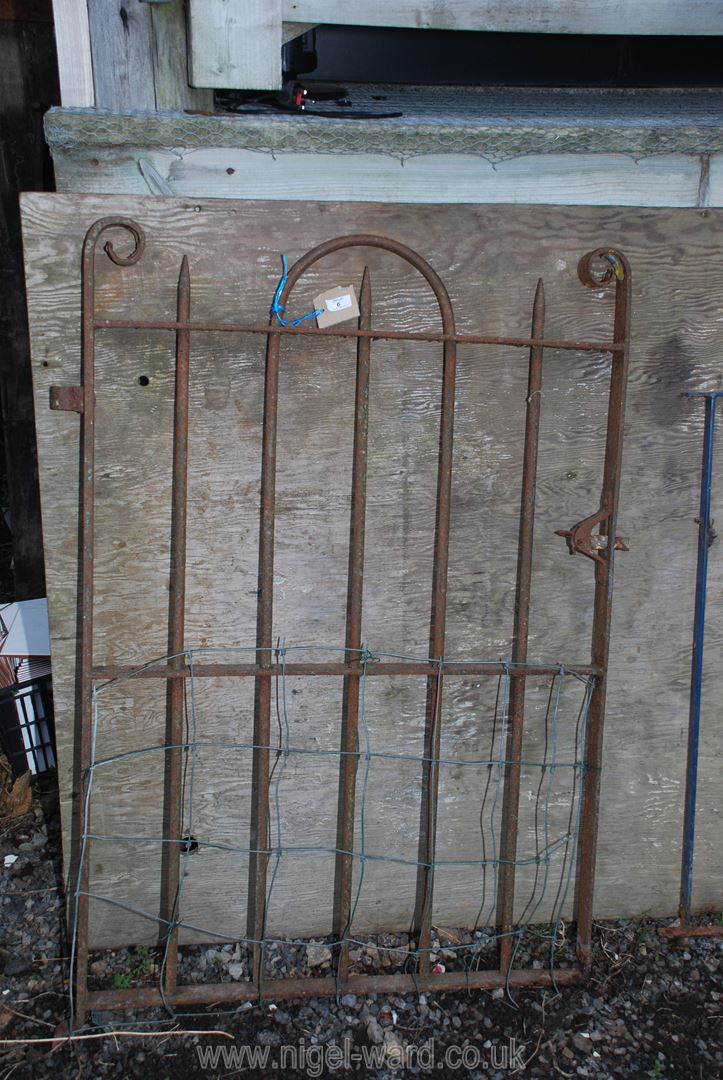A heavy metal garden gate with spike tops 33" x 46".
