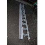 An aluminium 11 rung triple ladder.