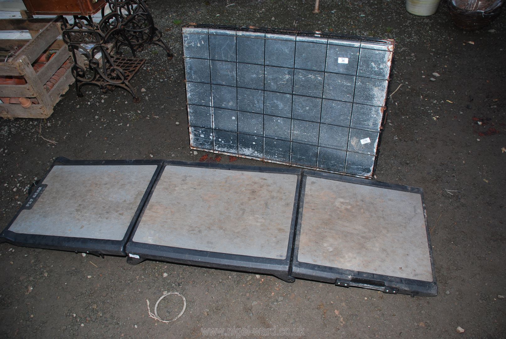 A folding pet ramp and metal dog crate.