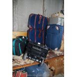 A pair of suitcases, a pull-along case, a shopping trolley and a hand luggage case.