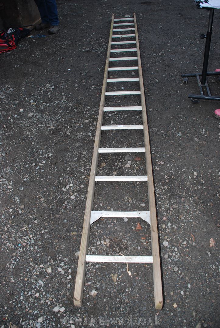 A 16 rung aluminium and wooden framed ladder.